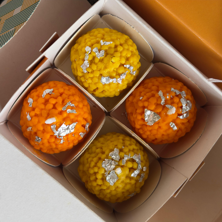 Yellow & orange ladoo-shaped soy wax candles for Diwali home decoration