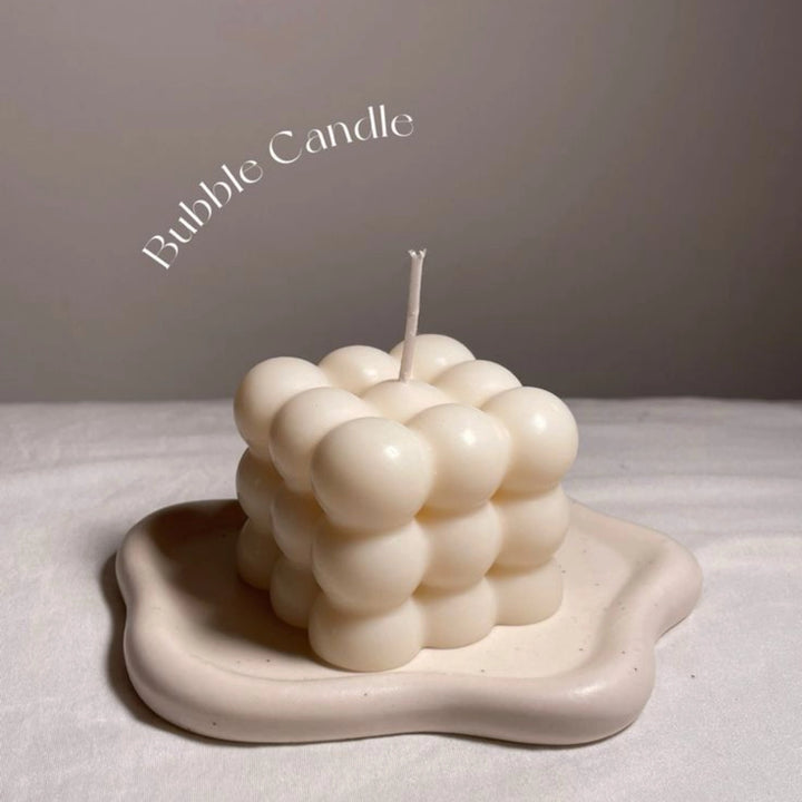 Big Bubble Candle Minimal aesthetic bubble candle glowing with a soft flame, placed near a sheer curtain on a white surface—ideal for home decor.