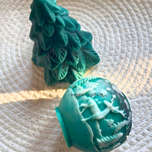 Teal Christmas tree and ornament with reindeer on a textured white  Handmade reindeer design Christmas sphere candlesurface