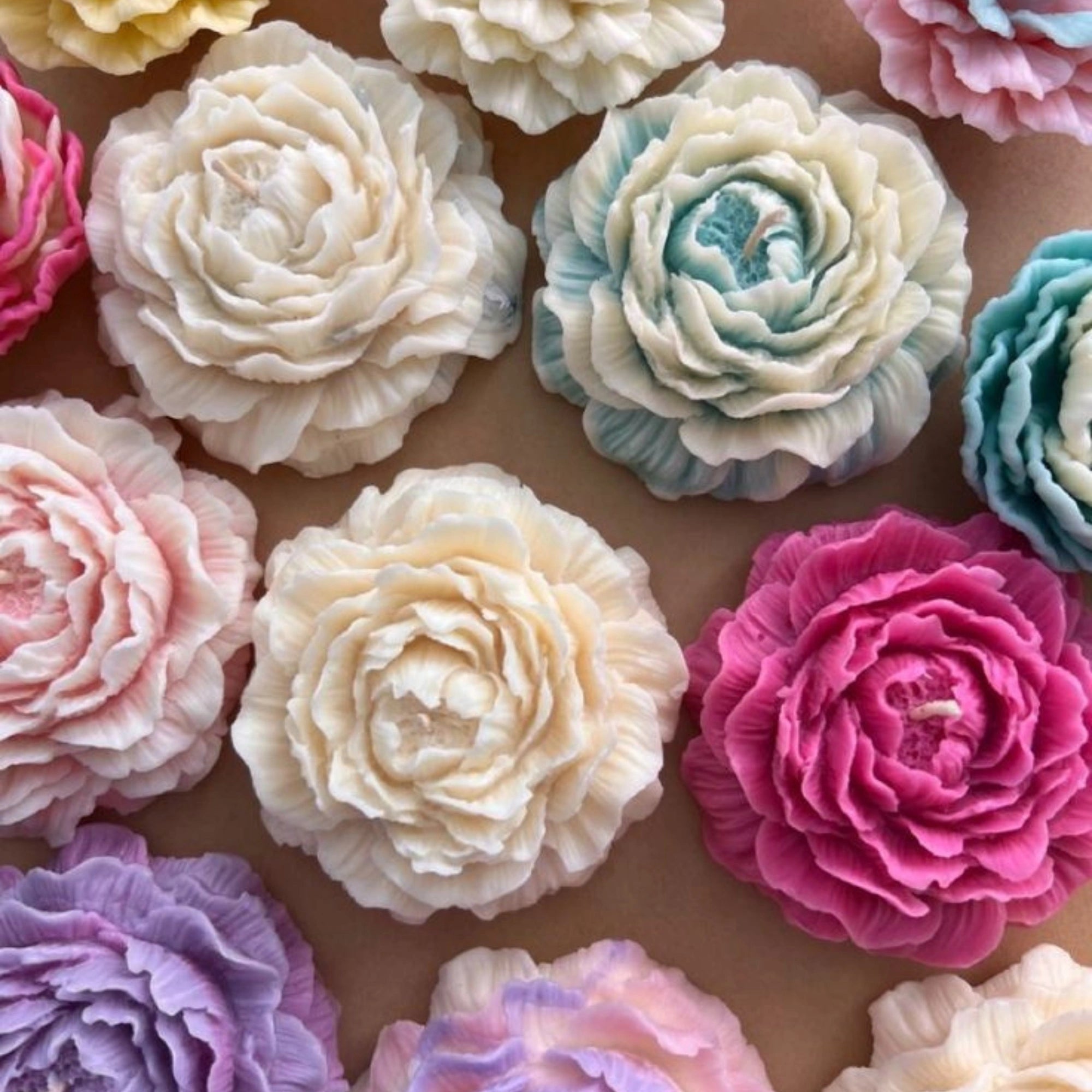 Bright pastel peony flower candles in orange, blue, lavender, and coral shades on kraft background. pinteresty flower candle , rose candle , rose day candle , gifts for her